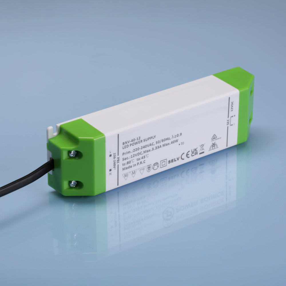 40W Green and white electronic component on a reflective surface with a light blue background