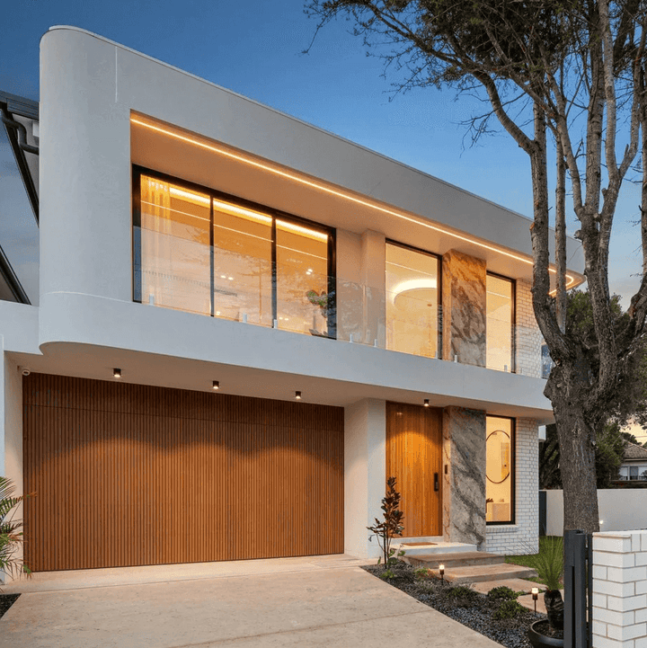 Modern house exterior with wooden garage door and glass windows