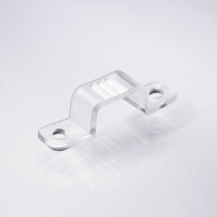 Clear plastic clip on a light gray background